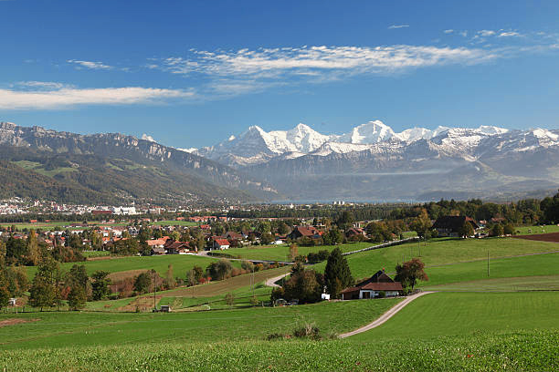View across fields to Swiss Alps and Interlaken, Bernese Oberland